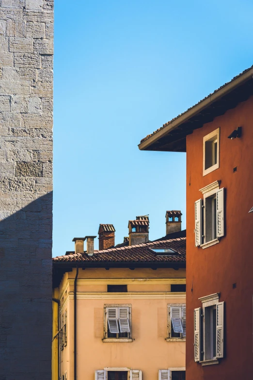 a couple of buildings that are next to each other, a picture, inspired by Carlo Maderna, pexels contest winner, neoclassicism, high walls, sunny at noon, square, color photo