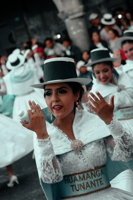 a group of people that are standing in the street, an album cover, trending on unsplash, quito school, wearing cylinder hat, white gloves, celebration costume, ( ( theatrical ) )