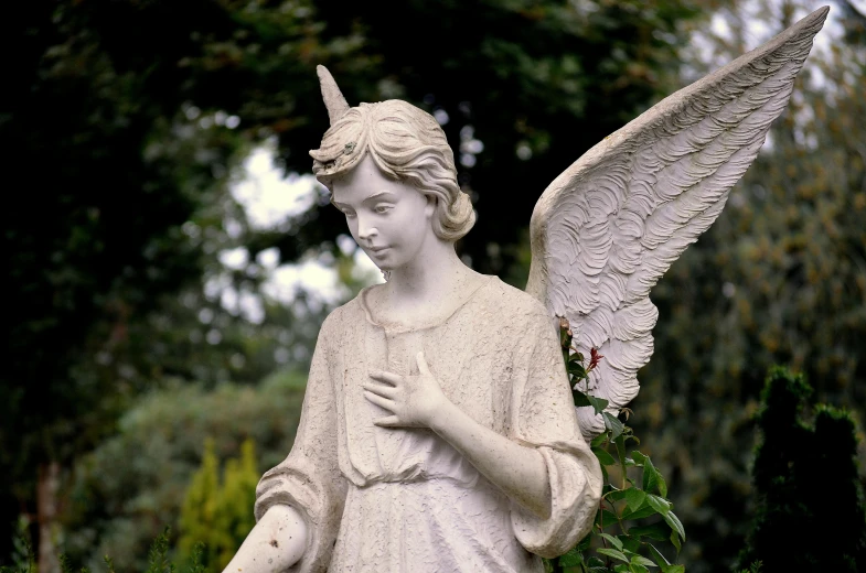 a statue of an angel in a garden, inspired by Jane Nasmyth, pixabay, taken on a 1960s kodak camera, wearing winged helmet, 1990's photo, david febland