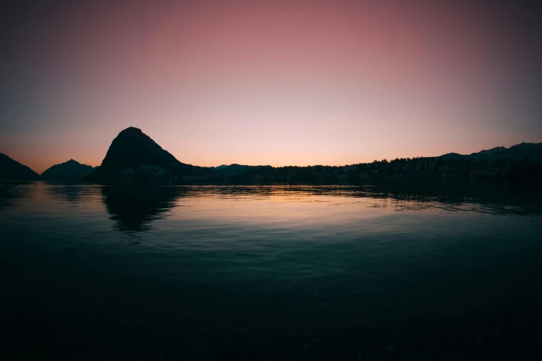 a body of water with mountains in the background, a picture, unsplash contest winner, romanticism, dusk light, medium format, multiple stories, silhouette :7