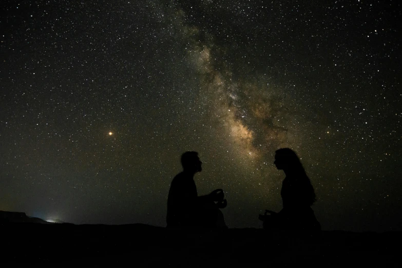 a couple of people standing next to each other under a night sky, sitting down, spiritual science, infinite, brown