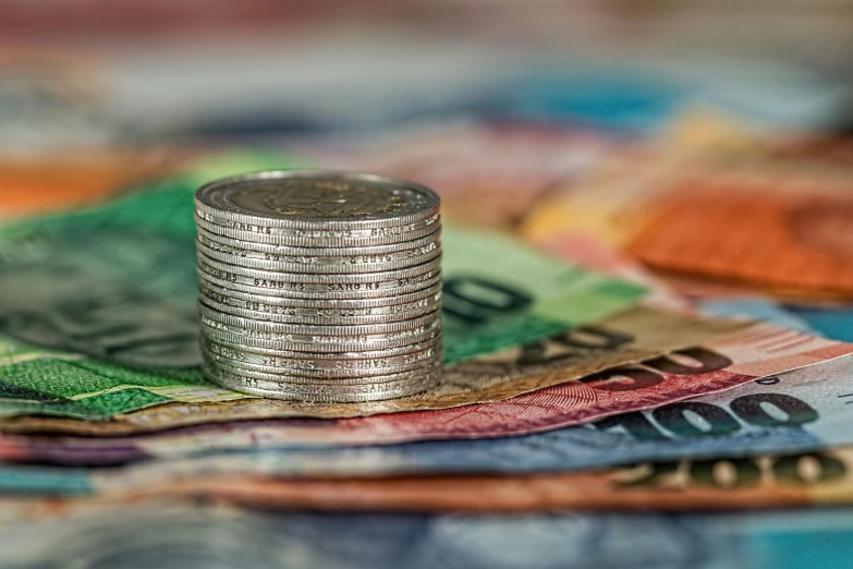 a stack of coins sitting on top of a pile of money, by Daniel Lieske, pexels contest winner, photorealism, multi - coloured, australian, avatar image, shallow depth of fielf