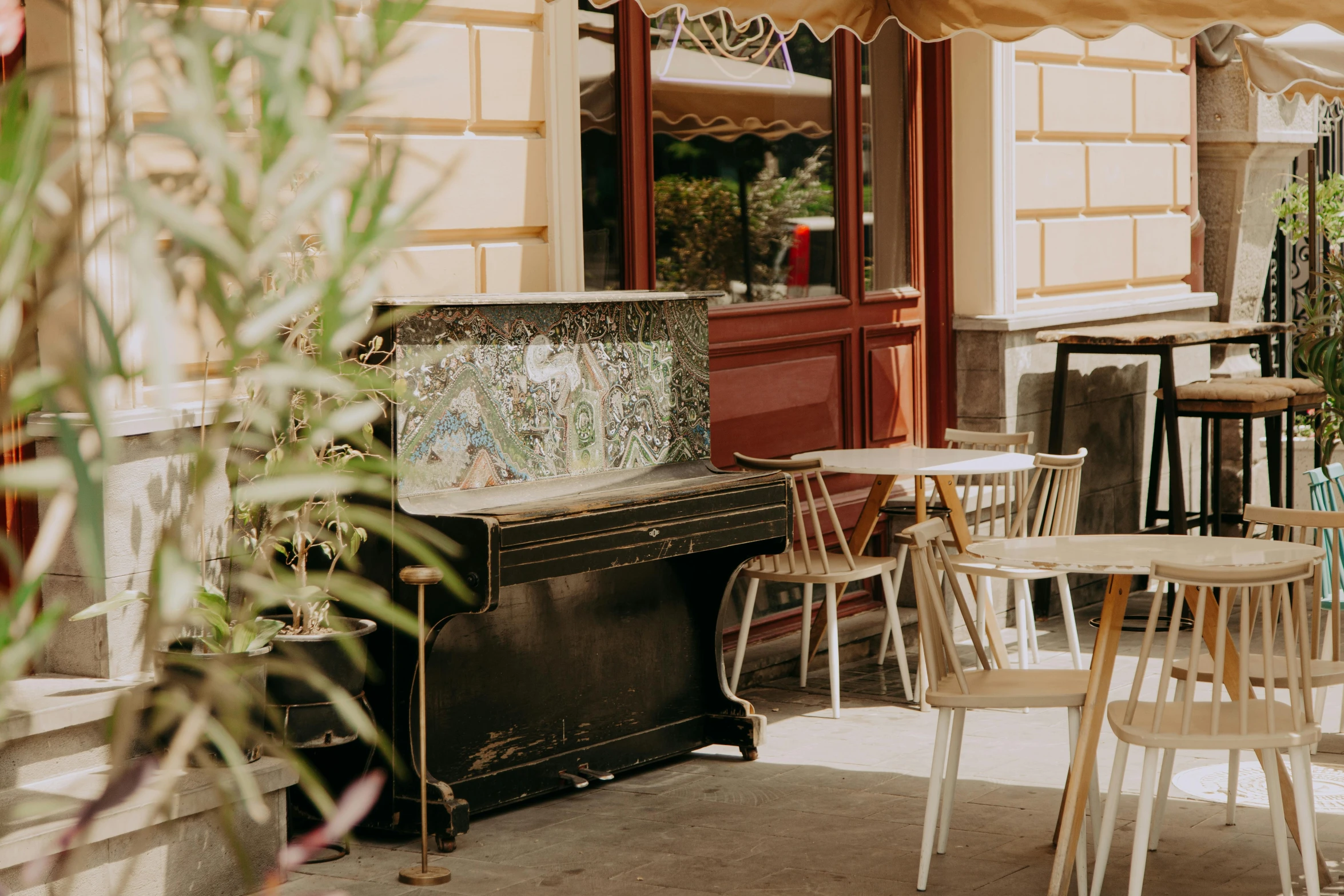 a piano sitting on top of a sidewalk next to a building, unsplash, art nouveau, cafe tables, background image, full body image