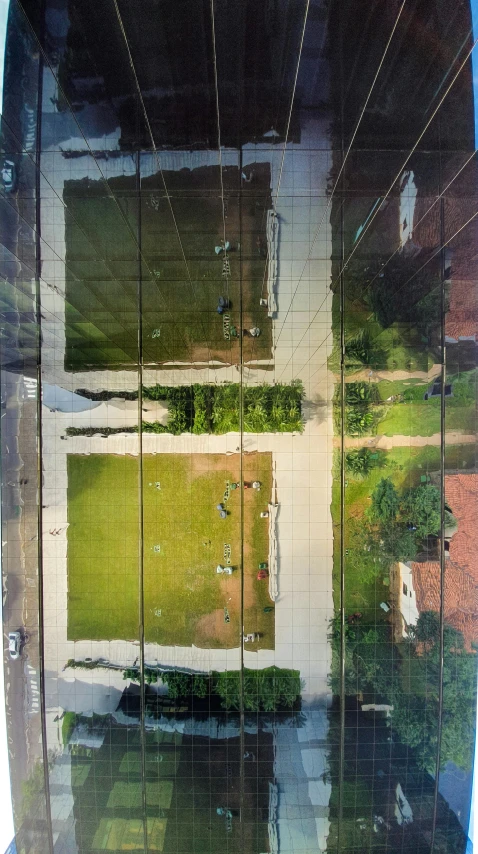 a reflection of a tennis court in a mirror, inspired by János Nagy Balogh, helicopter view, square, in sao paulo, an abandonded courtyard