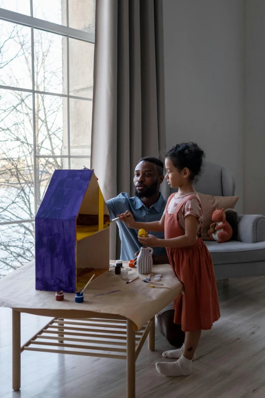 a man and a woman sitting on a couch in a living room, by artist, pexels contest winner, kids toy, lavander and yellow color scheme, neighborhood outside window, cardboard