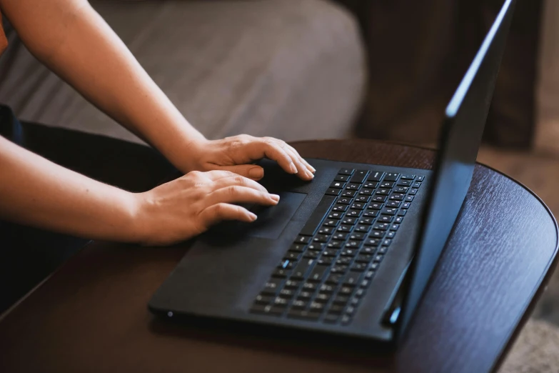 a close up of a person typing on a laptop, by Carey Morris, pexels, worksafe. instagram photo, schools, sitting in a lounge, black