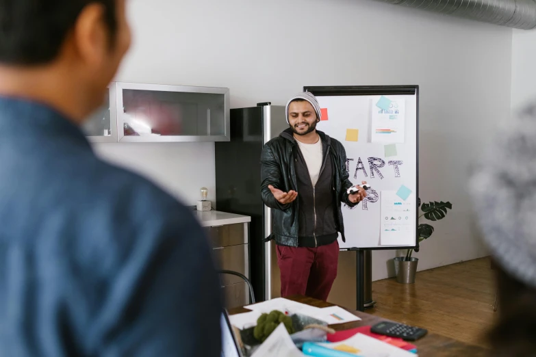 a man giving a presentation to a group of people, pexels contest winner, te pae, riyahd cassiem, casually dressed, whiteboard