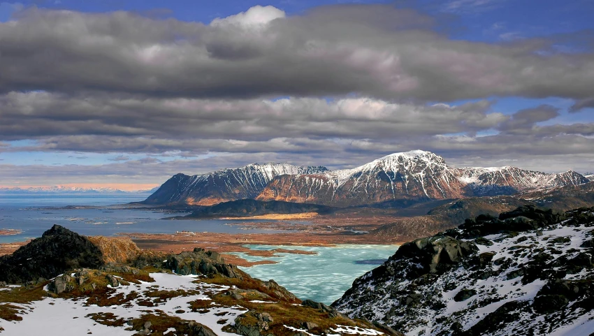 a person riding skis on top of a snow covered slope, hovering above a lake in yukon, deep colours. ”, overlooking a valley, award - winning photo ”