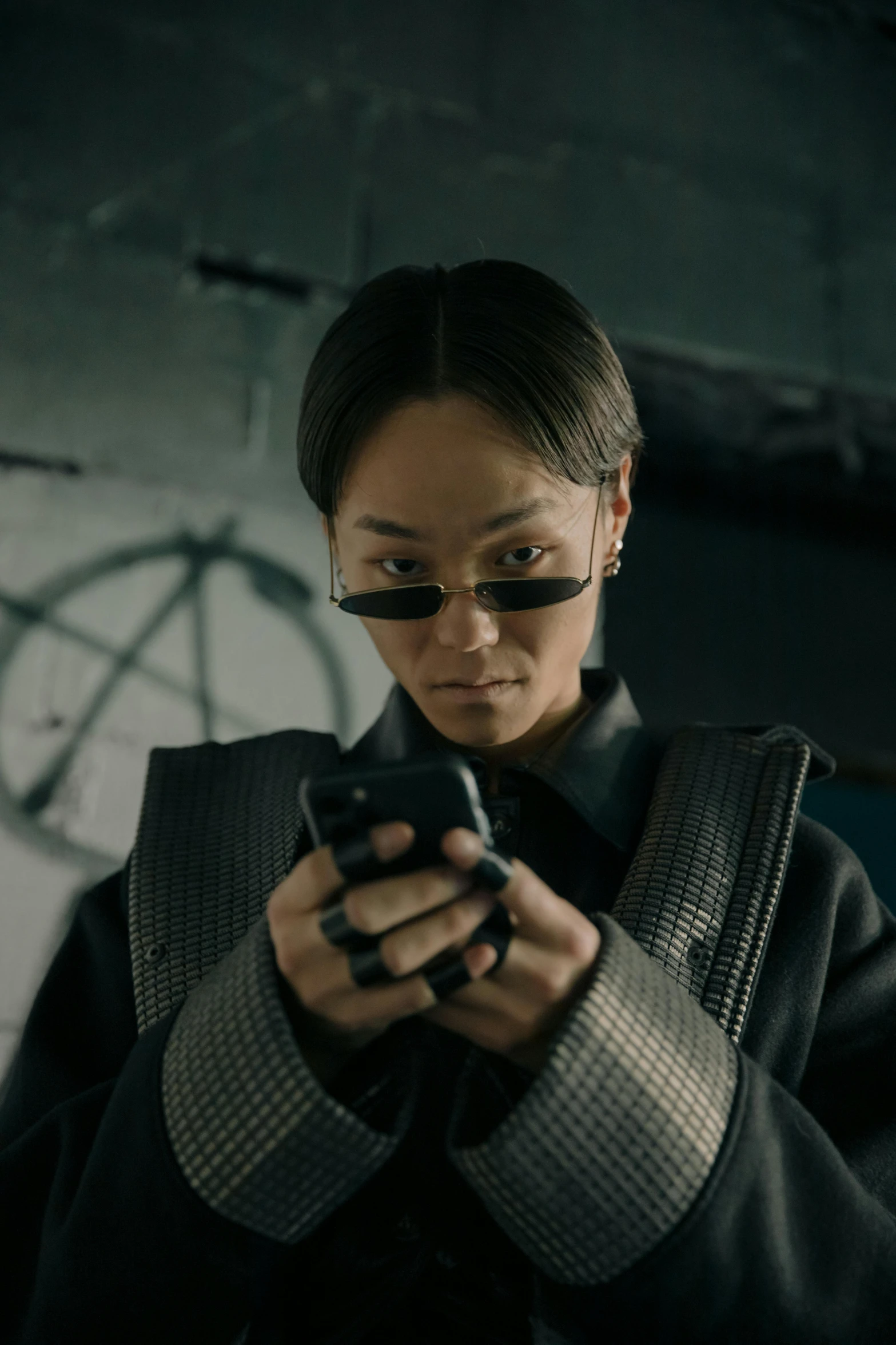 a woman is looking at her cell phone, a hologram, inspired by Feng Zhu, trending on pexels, neo-dada, doc ock, badass look, detective, [ theatrical ]