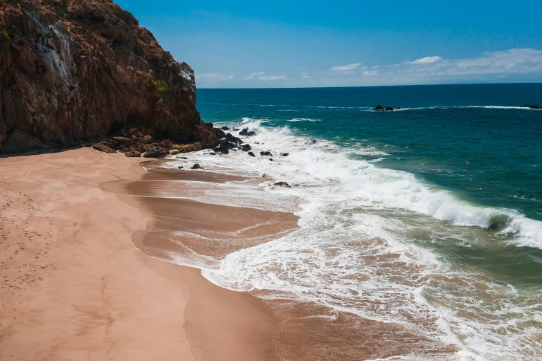 a sandy beach next to the ocean on a sunny day, pexels contest winner, malibu canyon, 2 5 6 x 2 5 6 pixels, red sand, mexico
