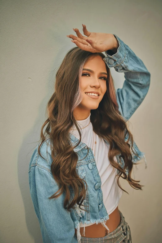 a woman with long hair wearing a denim jacket, by Robbie Trevino, trending on pexels, long wavy brown hair, product introduction photo, hair : long brown, promotional image