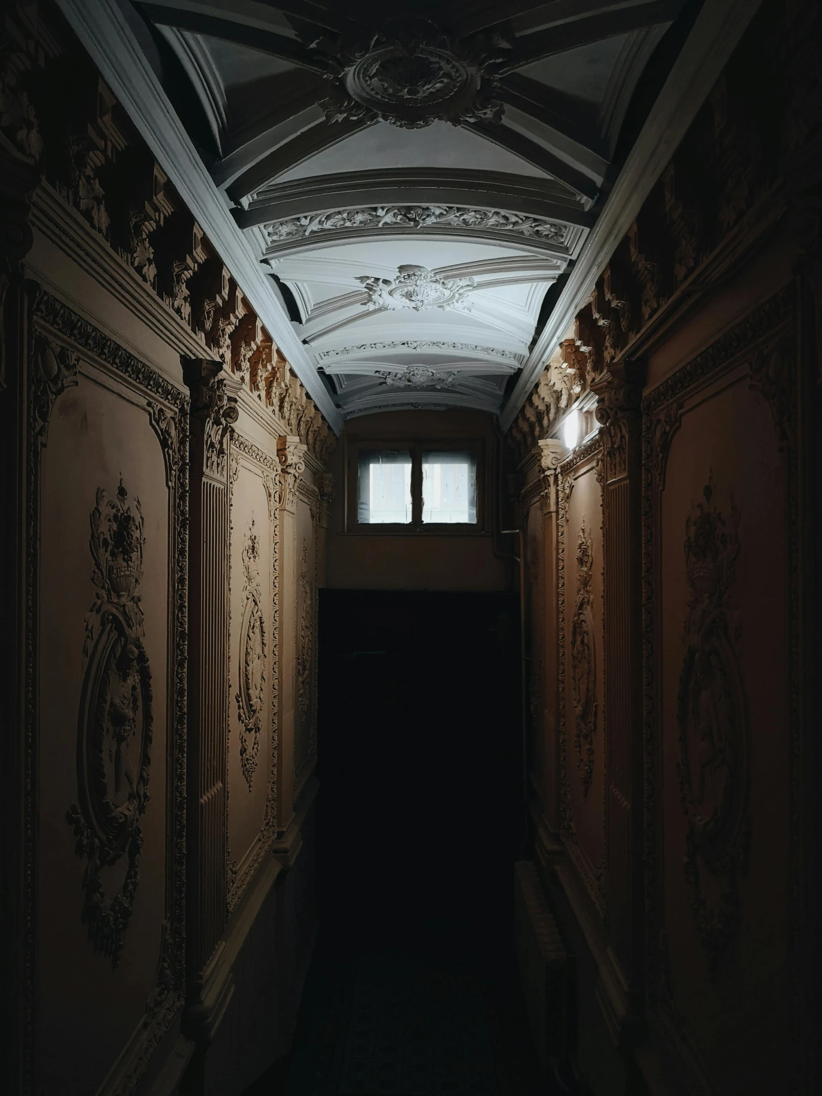 a dimly lit hallway in an old building, pexels contest winner, neoclassicism, style of michaelangelo, view from inside, gothic mansion, white ceiling