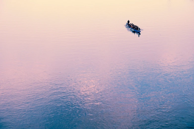 a small boat in the middle of a large body of water, by Andrew Geddes, unsplash contest winner, minimalism, pink sunset hue, small canoes, ignant, zoomed in