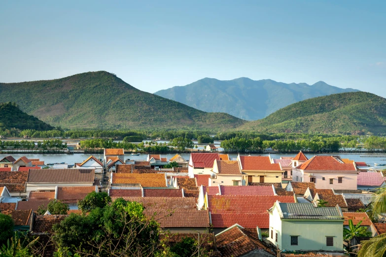 a view of a town with mountains in the background, inspired by Cui Bai, pexels contest winner, square, orange roof, ai weiwei and gregory crewdson, cuba