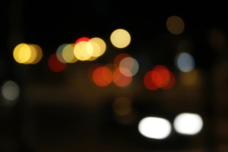 a blurry photo of a city street at night, a picture, unsplash, lyrical abstraction, overcast bokeh - c 5, car lights, macro bokeh ”, multicoloured