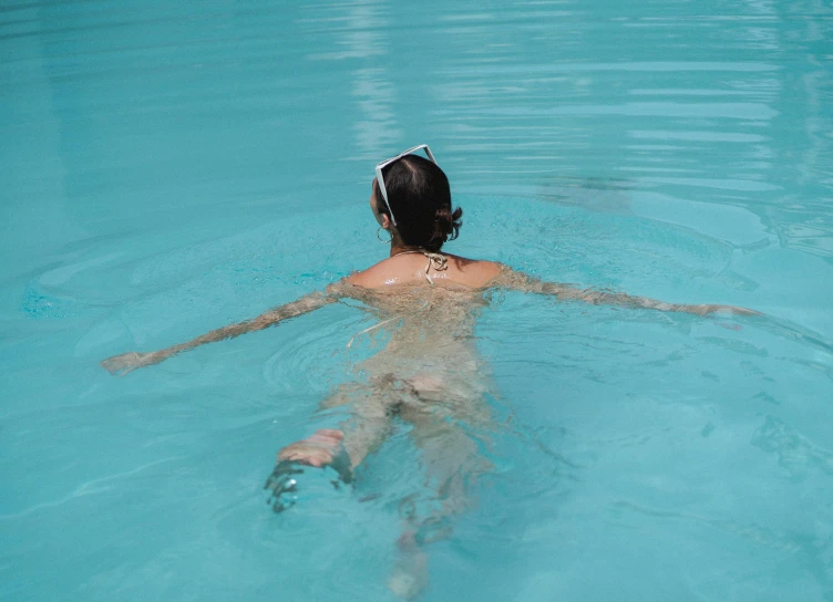 a person swimming in a pool with a frisbee, inspired by Elsa Bleda, pexels contest winner, back facing, spa, full body image, rectangle