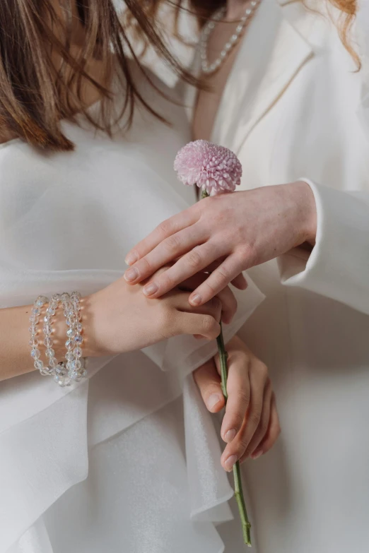 a close up of a person holding a flower, jewelry, take my hand, dressed in white, translucent
