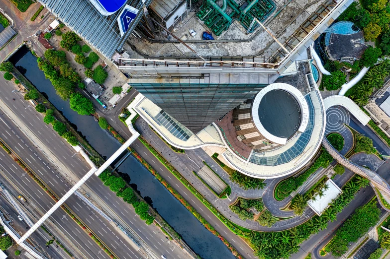 an aerial view of a building in a city, a screenshot, pexels contest winner, jakarta, flat curves, panels, helipad