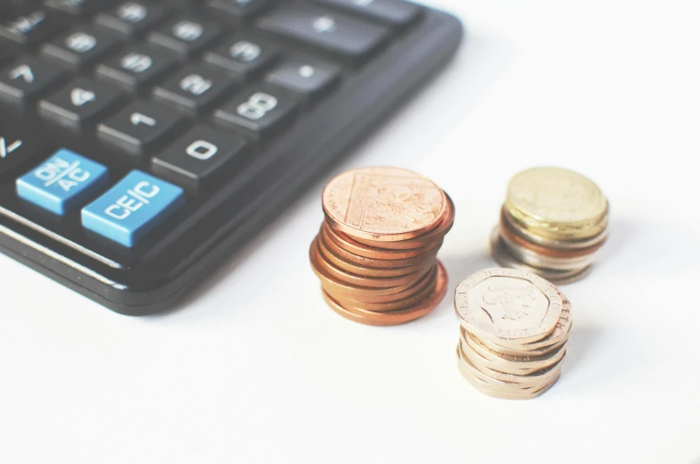 a calculator sitting next to a pile of coins, a photo, by Emma Andijewska, pexels, dau-al-set, instagram post, round-cropped, vtm, pastel'