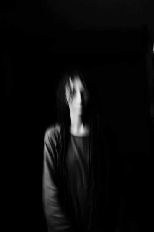 a black and white photo of a woman in the dark, inspired by Kati Horna, unsplash, conceptual art, long thin black hair, humanoid woman, blurred face, slenderman