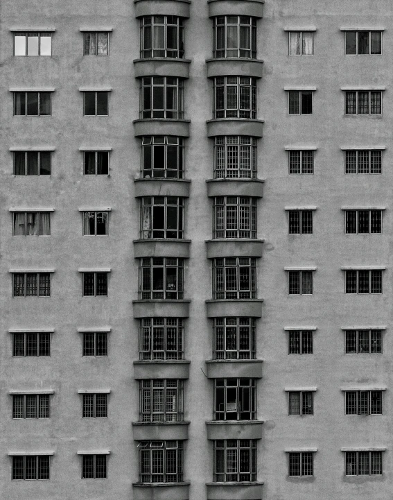 a black and white photo of a tall building, by Wang Yi, brutalism, house windows, soviet apartment building, monochrome:-2, made of cement