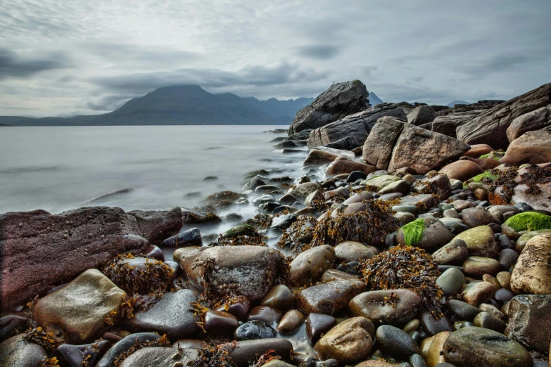 a rocky beach next to a body of water, inspired by Robert Macaulay Stevenson, pexels contest winner, highlands, avatar image