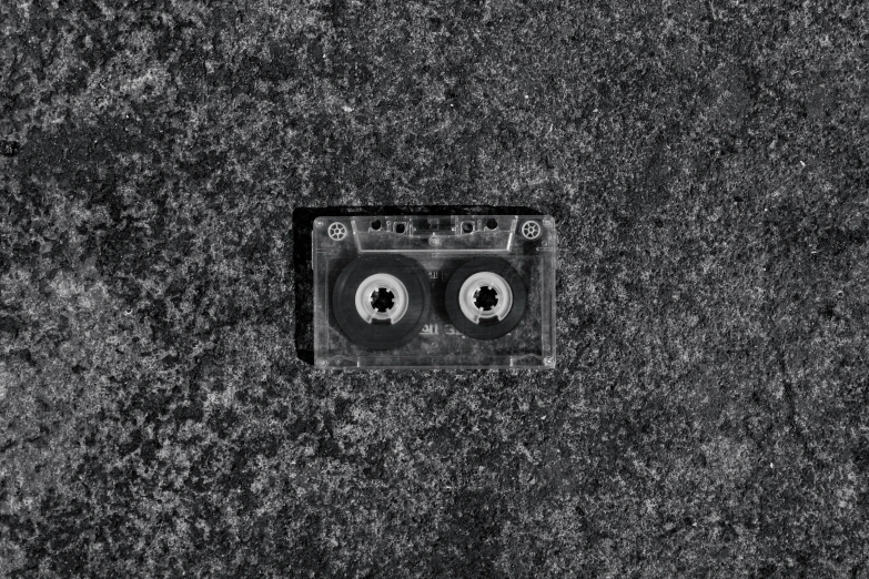 a black and white photo of a cassette, an album cover, by Jan Kupecký, dirty old grey stone, digital artwork, vibrant.-h 704, bird eye view