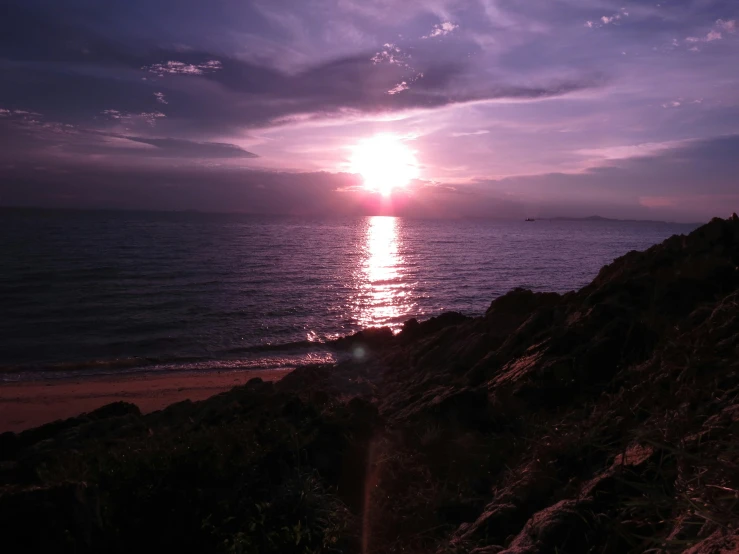 the sun is setting over a body of water, pexels contest winner, purple hues, seaview, low quality photo, shoreline