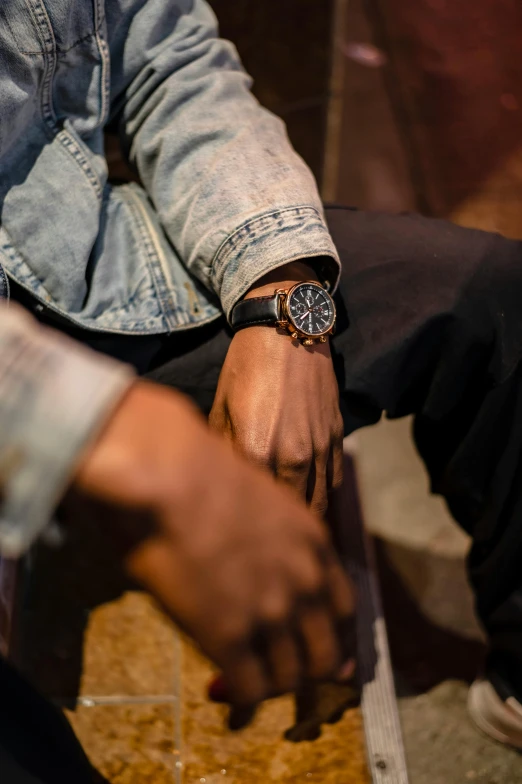 a close up of a person wearing a watch, visual art, sitting with wrists together, rugged details, black man, f / 2 0