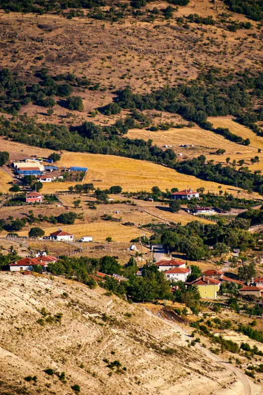 a view of a small town from the top of a hill, by Muggur, slide show, cyprus, fan favorite, grazing