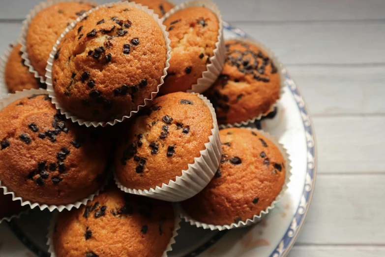 a close up of a plate of muffins on a table, pexels, hurufiyya, piled around, thumbnail, extremely high resolution, speckled