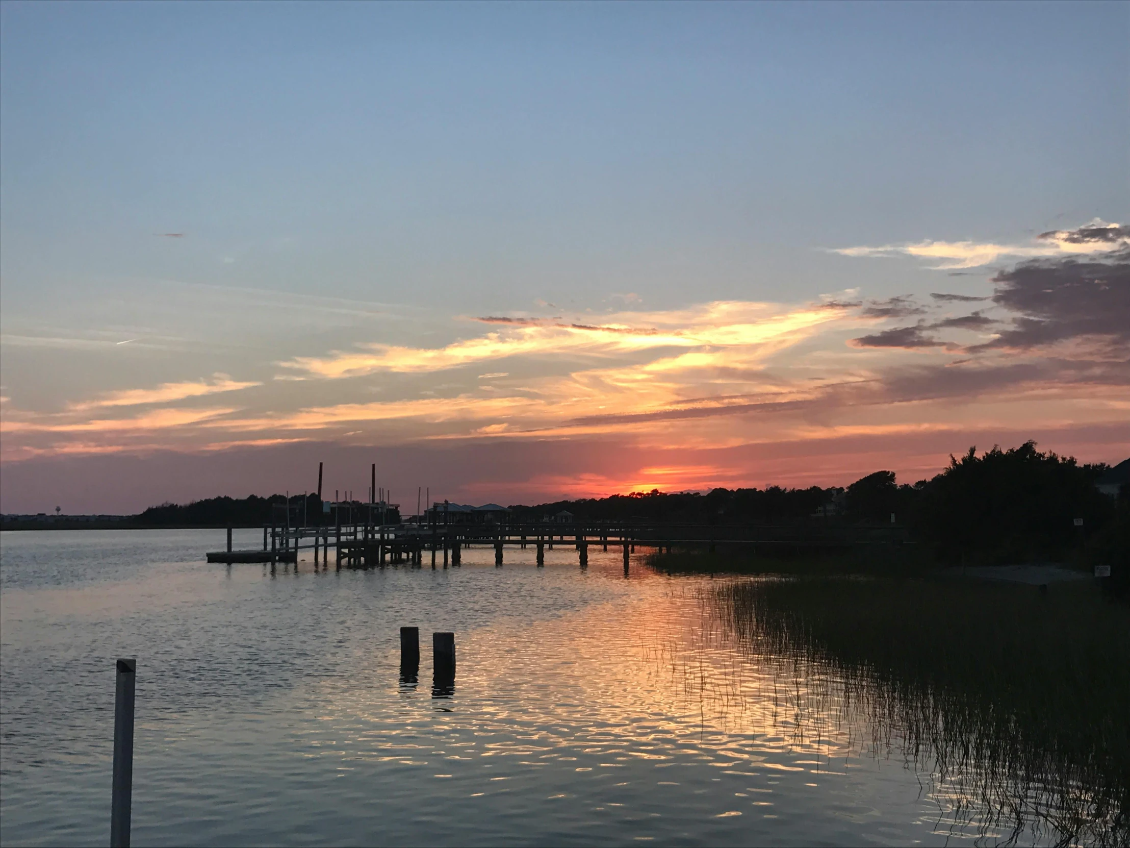 the sun is setting over a body of water, by Carey Morris, pexels contest winner, hurufiyya, upon a peak in darien, slide show, peaceful evening harbor, casey cooke