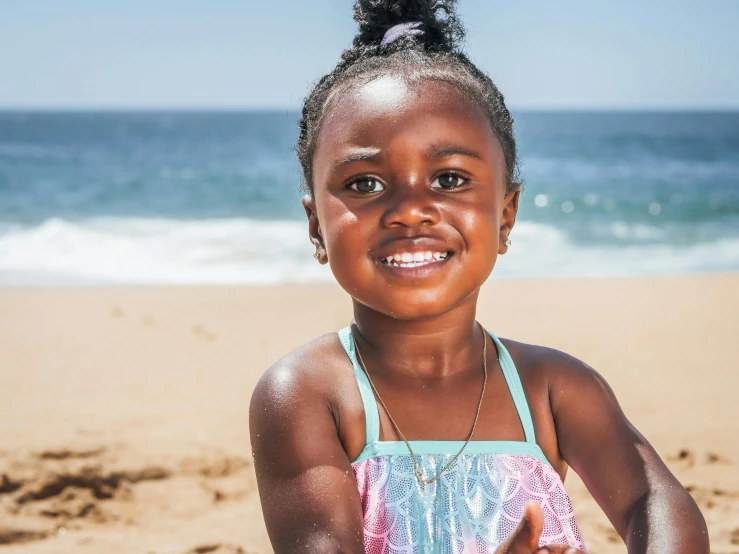 a little girl standing on top of a sandy beach, brown skin, african facial features, australian beach, a still of a happy