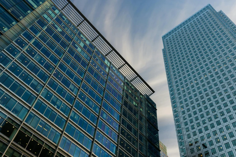 a couple of tall buildings next to each other, by Jay Hambidge, unsplash, modernism, square, corporate, offices, aquamarine windows