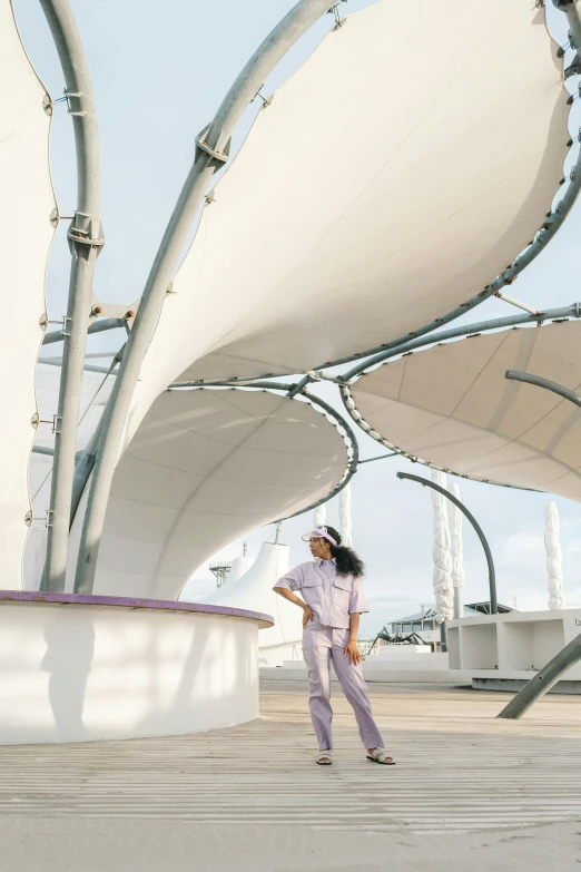 a woman standing in front of a large structure, inspired by Zha Shibiao, trending on unsplash, happening, white and purple, on a super yacht, canopy, puerto rico