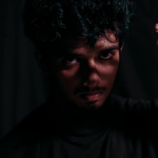a close up of a person holding a nintendo wii controller, a character portrait, by Alexis Grimou, pexels contest winner, dramatic serious pose, samurai with afro, darkness dramatic, done in the style of caravaggio