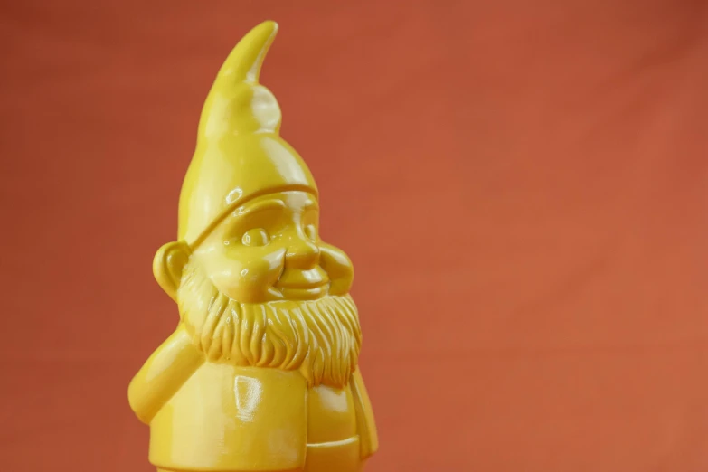 a yellow gnome figurine sitting on top of a table, by Sven Erixson, trending on polycount, pop art, close - up portrait shot, soap carving, shiny crisp finish, hd wallpaper