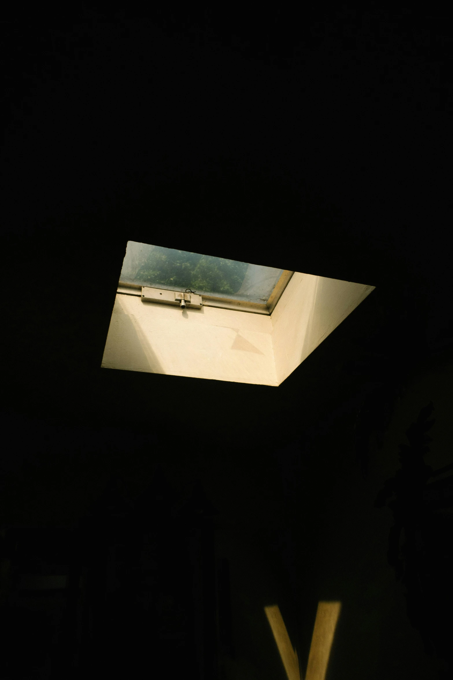 a window with a skylight above it in a dark room, an album cover, inspired by Elsa Bleda, unsplash, light and space, simple ceiling, taken in the late 2000s, liminal space aesthetic, afternoon