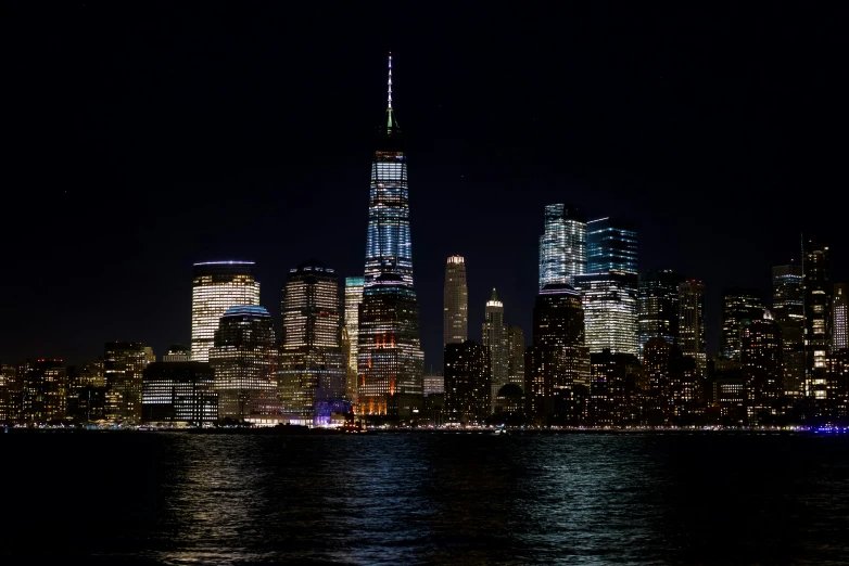 a view of a city at night from the water, 2022 photograph, fan favorite, new york city, full frame image