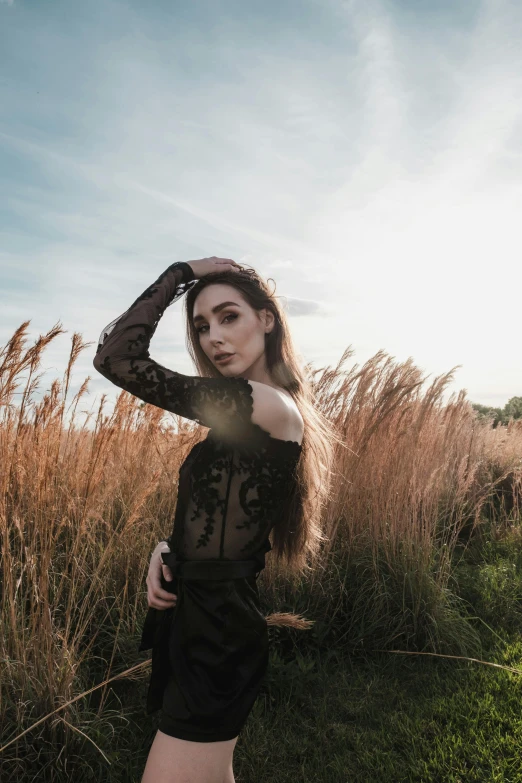 a woman in a black dress standing in a field, inspired by Elsa Bleda, pexels contest winner, renaissance, instagram model, at a fashion shoot, various posed, pose 4 of 1 6