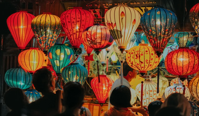 a group of people standing in front of a display of lanterns, pexels contest winner, maximalism, 🦩🪐🐞👩🏻🦳, vietnamese woman, cosy atmosphere, profile image