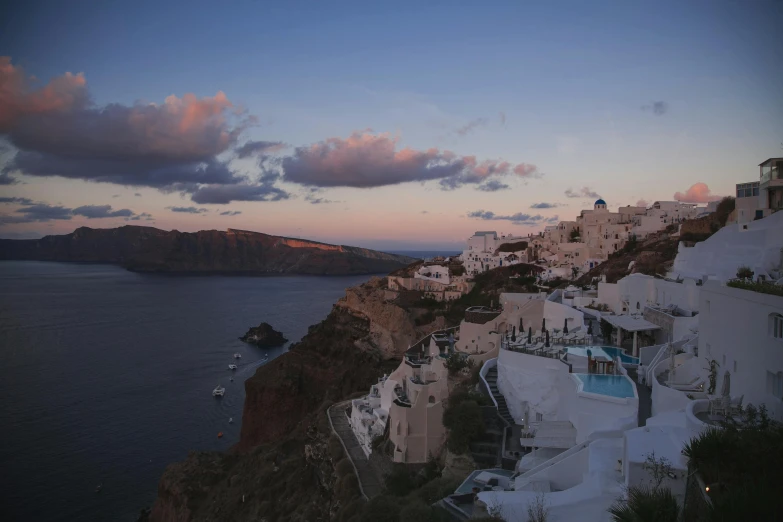 a view of some buildings and a body of water, pexels contest winner, greek nose, late evening, hills and ocean, slide show