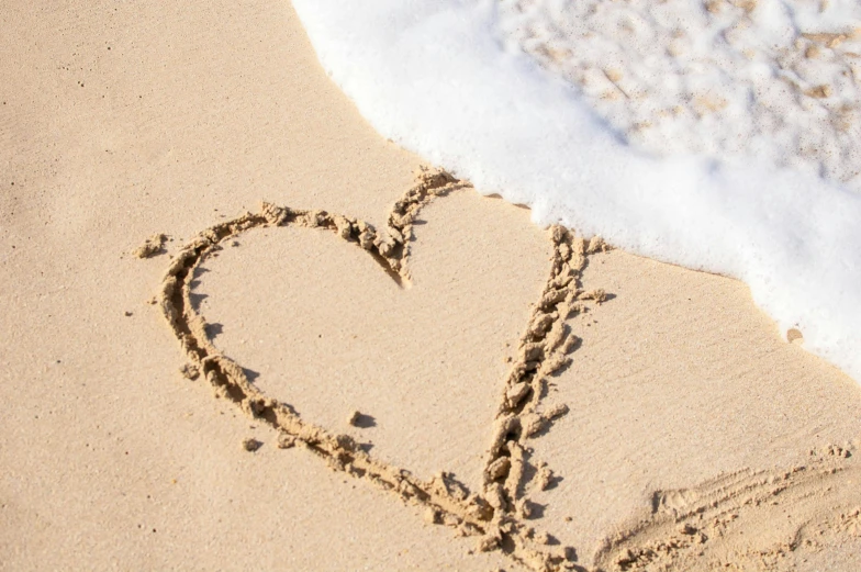 a heart drawn in the sand on a beach, pexels, fan favorite, light tan, profile picture, vanilla