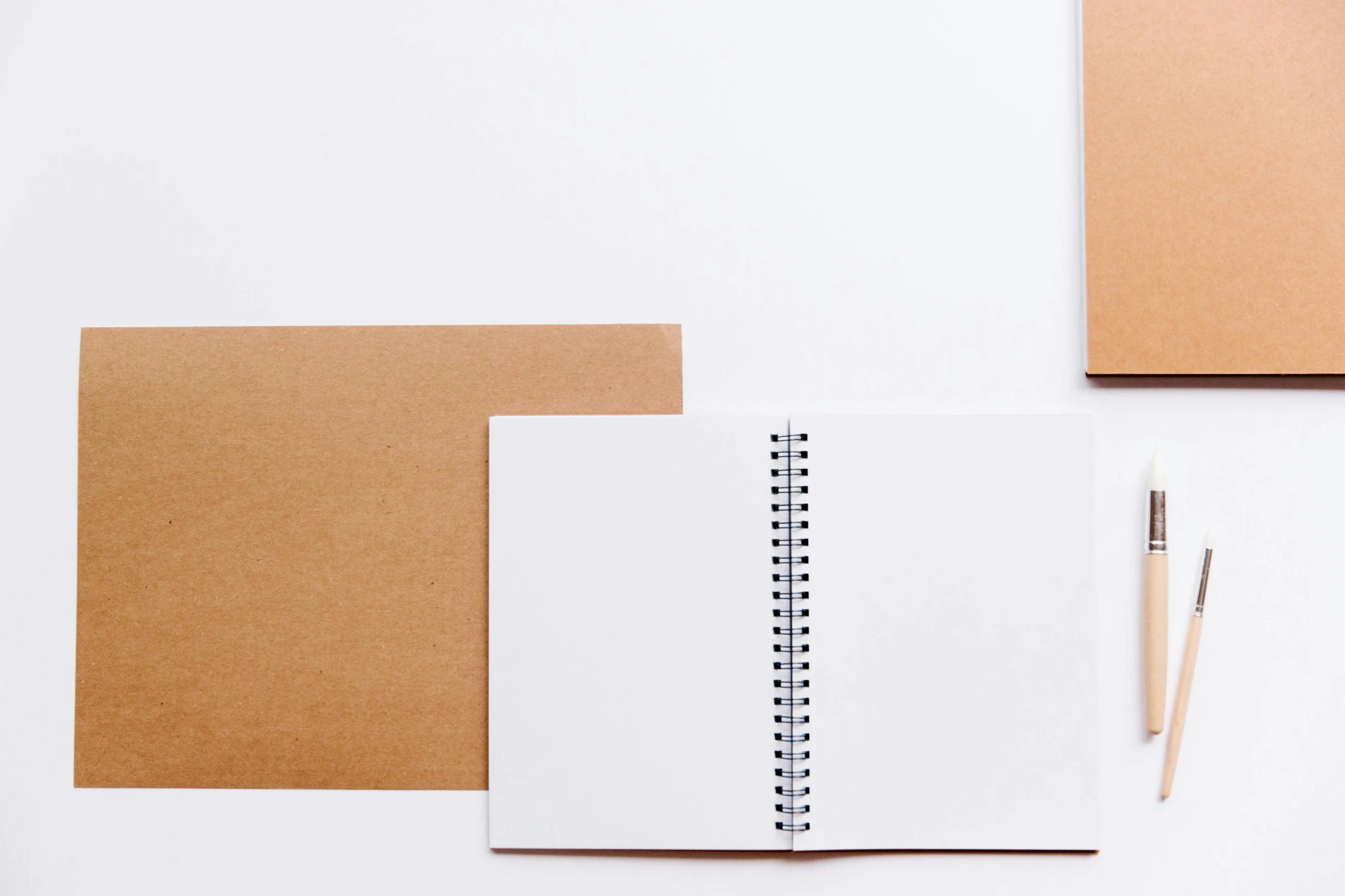 a notepad, pen, and notebook on a white surface, an album cover, trending on unsplash, visual art, background image, brown paper, 9 9 designs, no - text no - logo