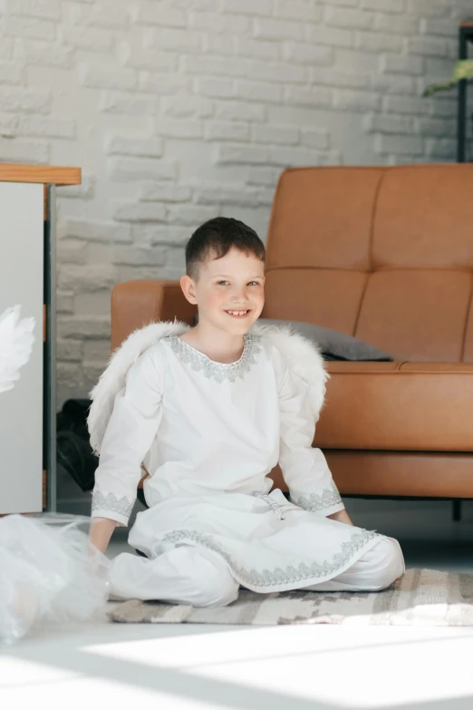 a little boy dressed up as an angel sitting on the floor, pexels contest winner, on a couch, matt white ice color armor, 15081959 21121991 01012000 4k, young teen