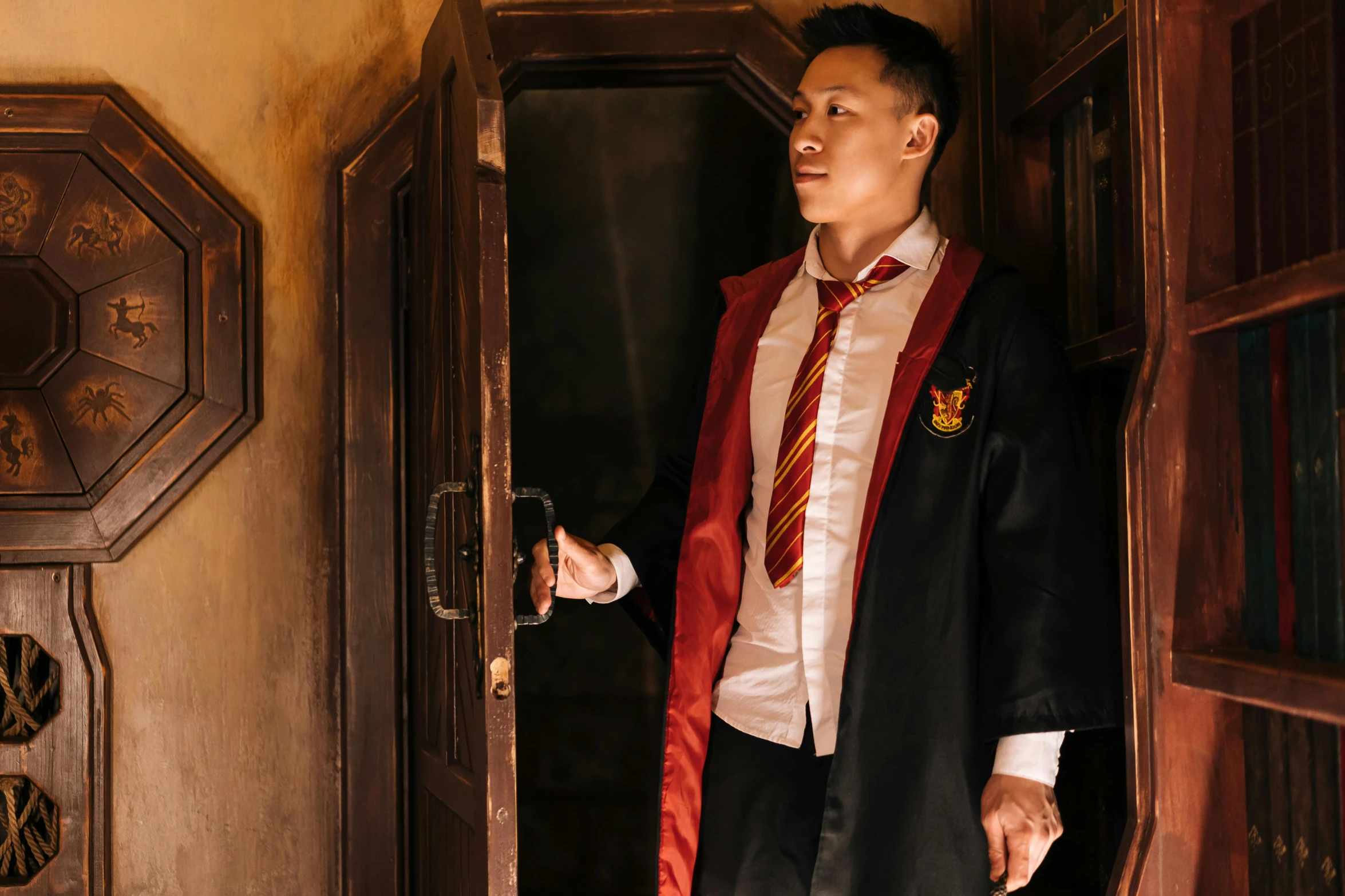 a man in a robe and tie standing in a doorway, pexels contest winner, happening, hogwarts gryffindor common room, yanjun chengt, wearing hero costume, ( ( theatrical ) )