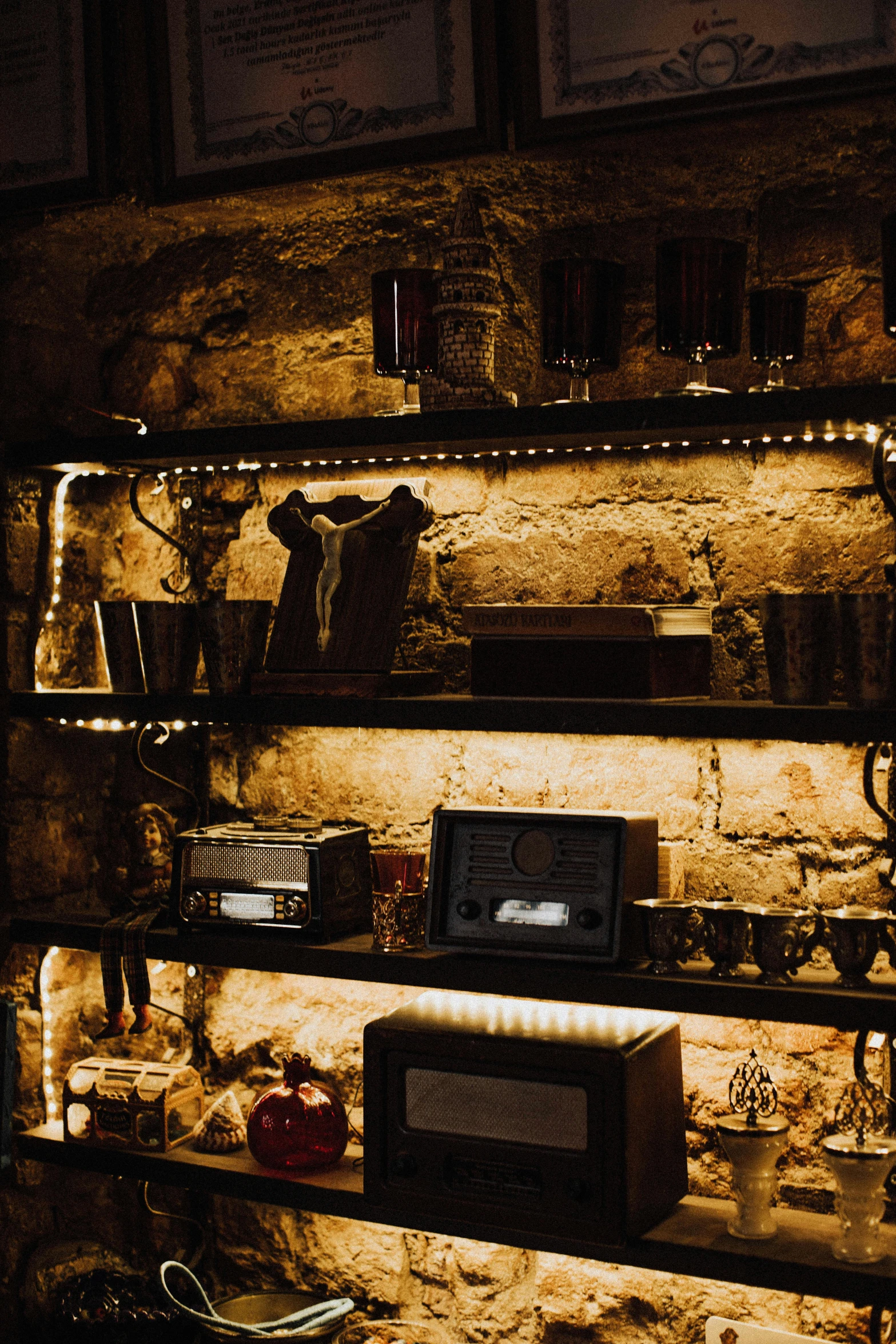 a shelf that has some lights on it, unsplash, renaissance, cellar, brass equipment and computers, speakeasy, grotto