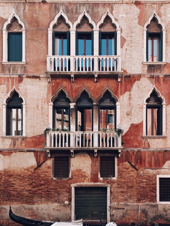 a boat sitting on top of a river next to a building, inspired by Canaletto, pexels contest winner, renaissance, house windows, freddy mamani silvestre facade, brown, profile image