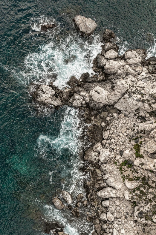 a large body of water next to a rocky shore, pexels contest winner, looking down from above, charybdis, capri coast, today\'s featured photograph 4k