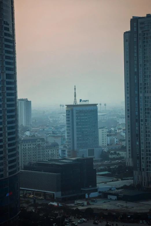 a view of a city from a high rise building, inspired by Zhang Kechun, unsplash contest winner, vietnam, light haze, brutalist buildings tower over, gigapixel photo